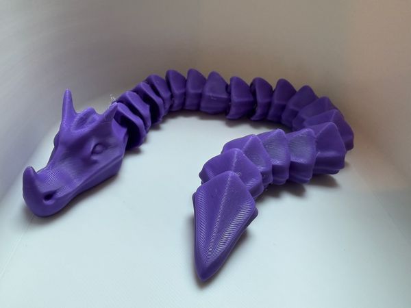 3d printed flexi dragons (wyrms of various colors)
